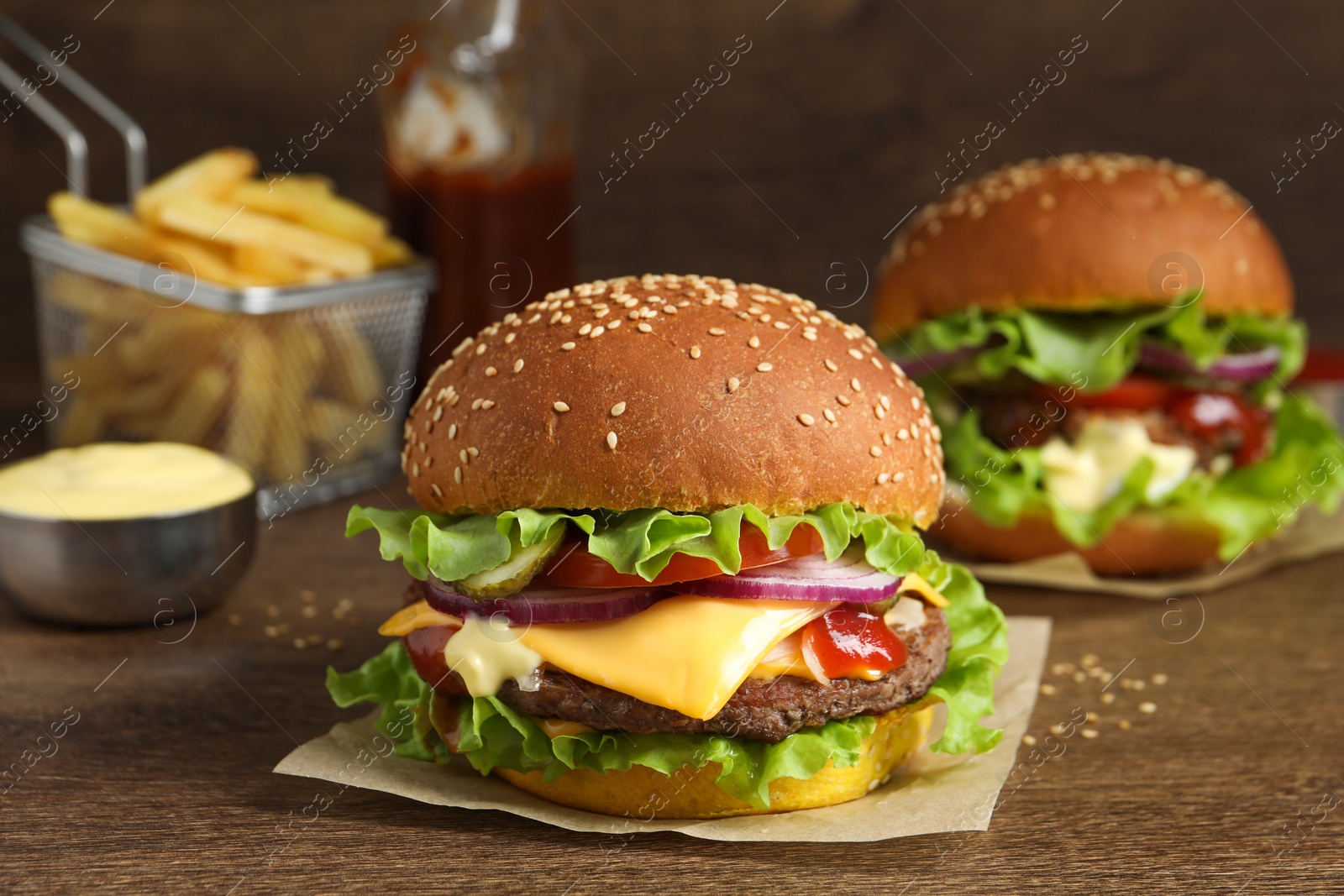 Photo of Delicious burgers with beef patty on wooden table