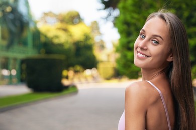 Photo of Portrait of beautiful young woman on city street, space for text