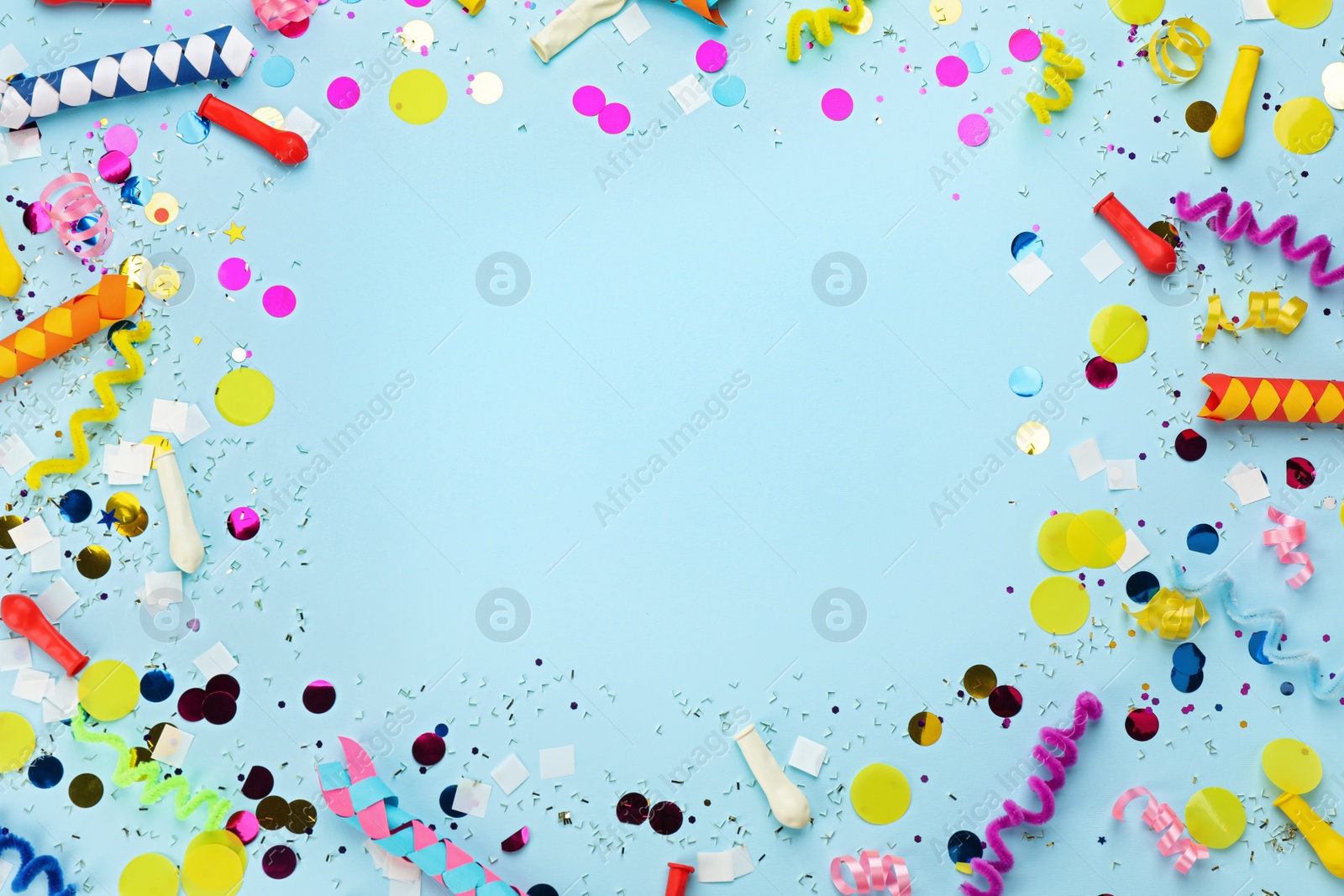 Photo of Frame made with carnival items on light blue background, flat lay. Space for text