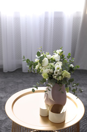 Photo of Beautiful bouquet of flowers on table in room. Stylish interior design
