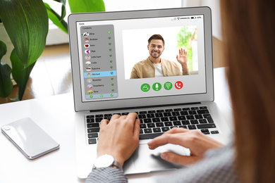 Image of Woman having online meeting with her colleague via laptop, closeup