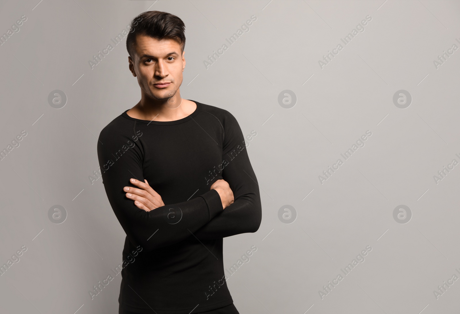 Photo of Man wearing thermal underwear on grey background. Space for text