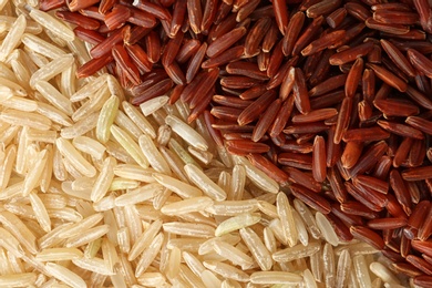 Brown and other types of rice as background, closeup