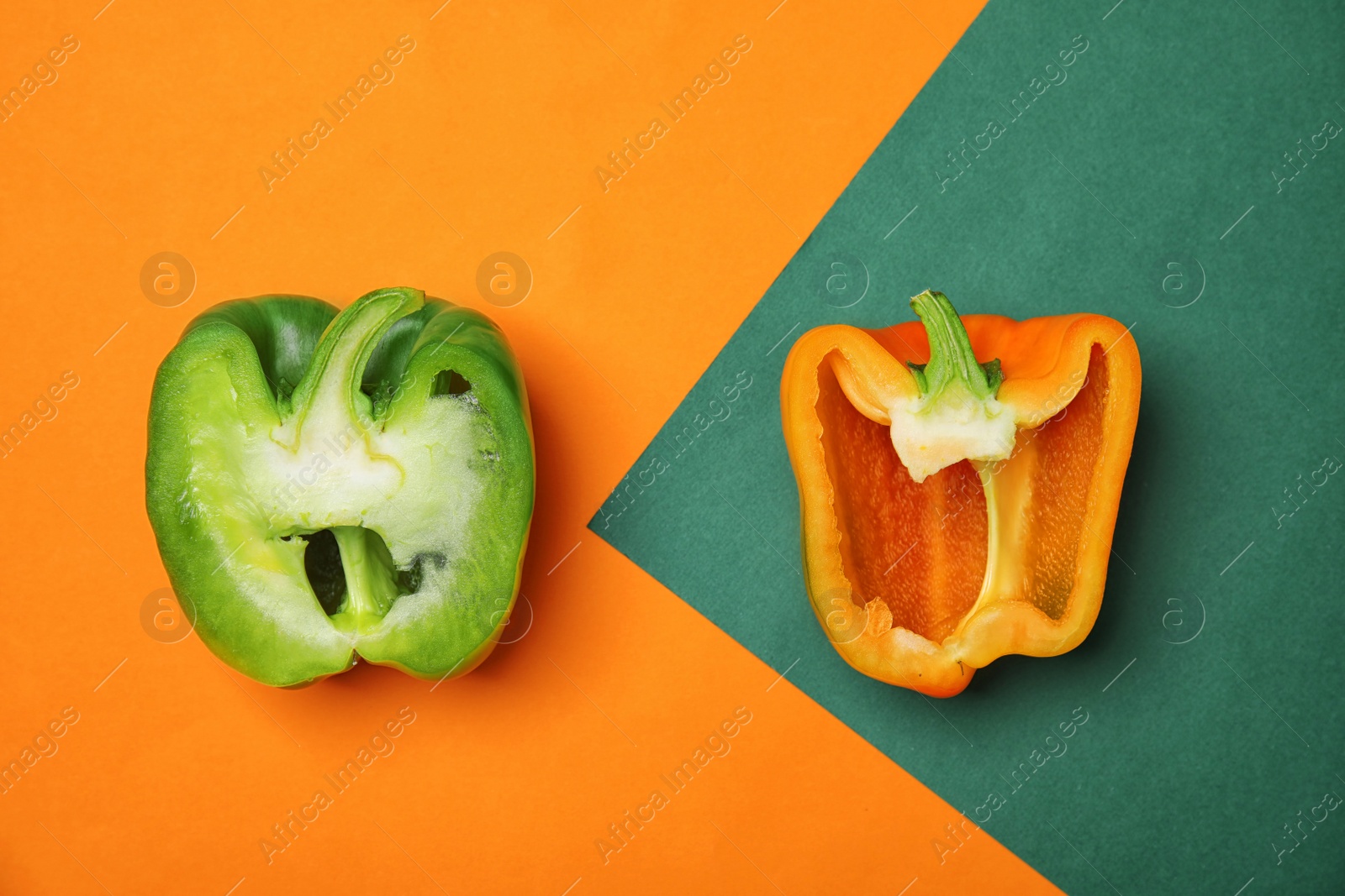 Photo of Cut paprika peppers on color background, top view