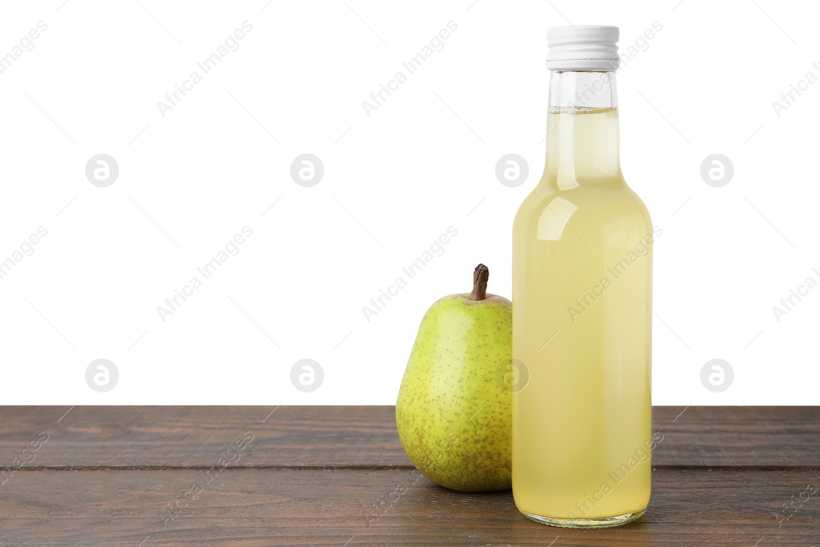 Photo of Delicious kombucha in glass bottle and pear on wooden table against white background, space for text