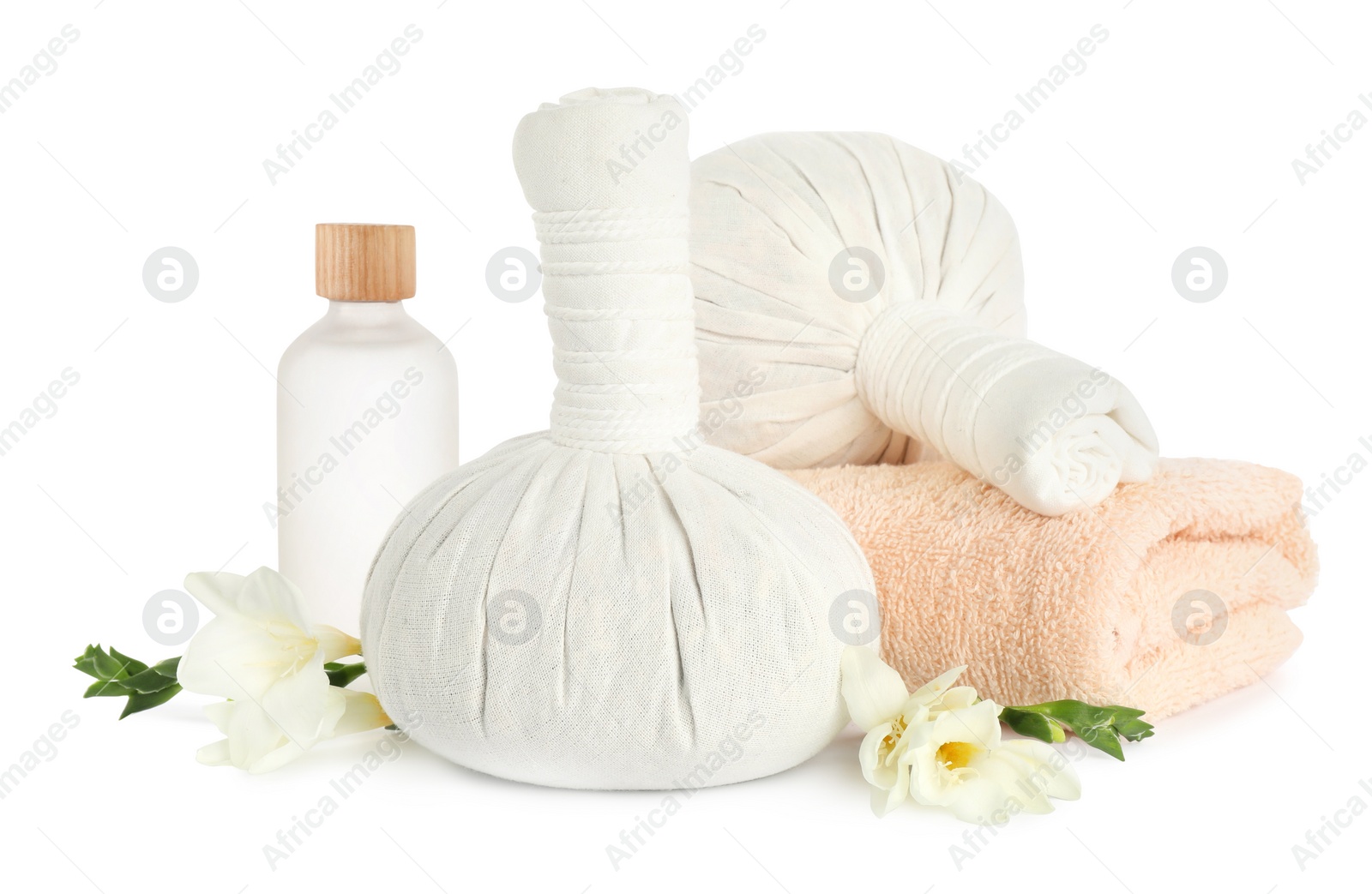 Photo of Herbal massage bags, essential oil, flowers and towel on white background. Spa procedure