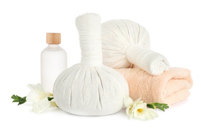 Photo of Herbal massage bags, essential oil, flowers and towel on white background. Spa procedure