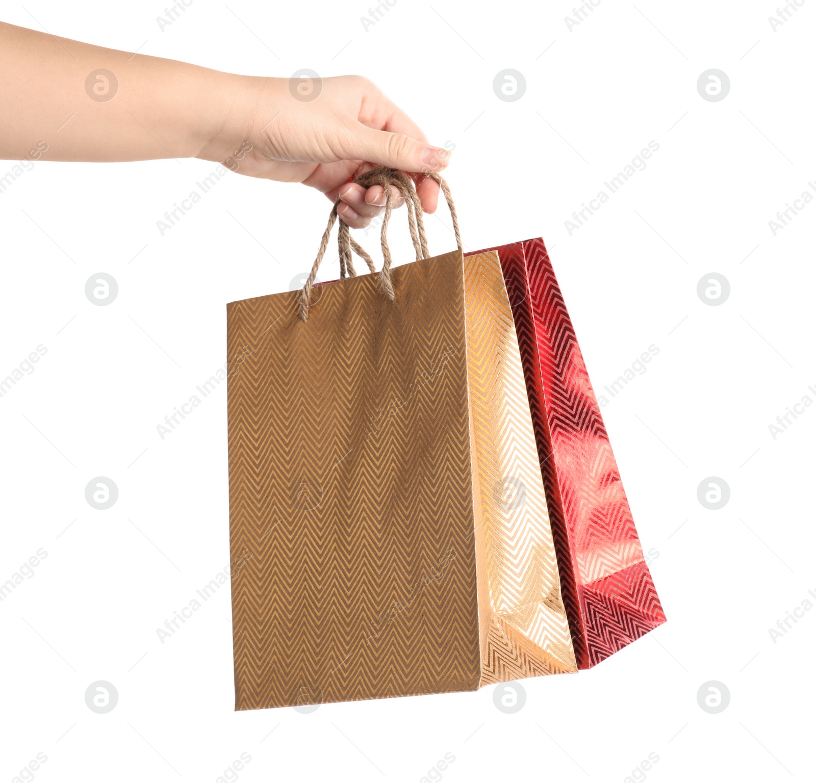 Photo of Woman holding paper shopping bags on white background, closeup. Space for design