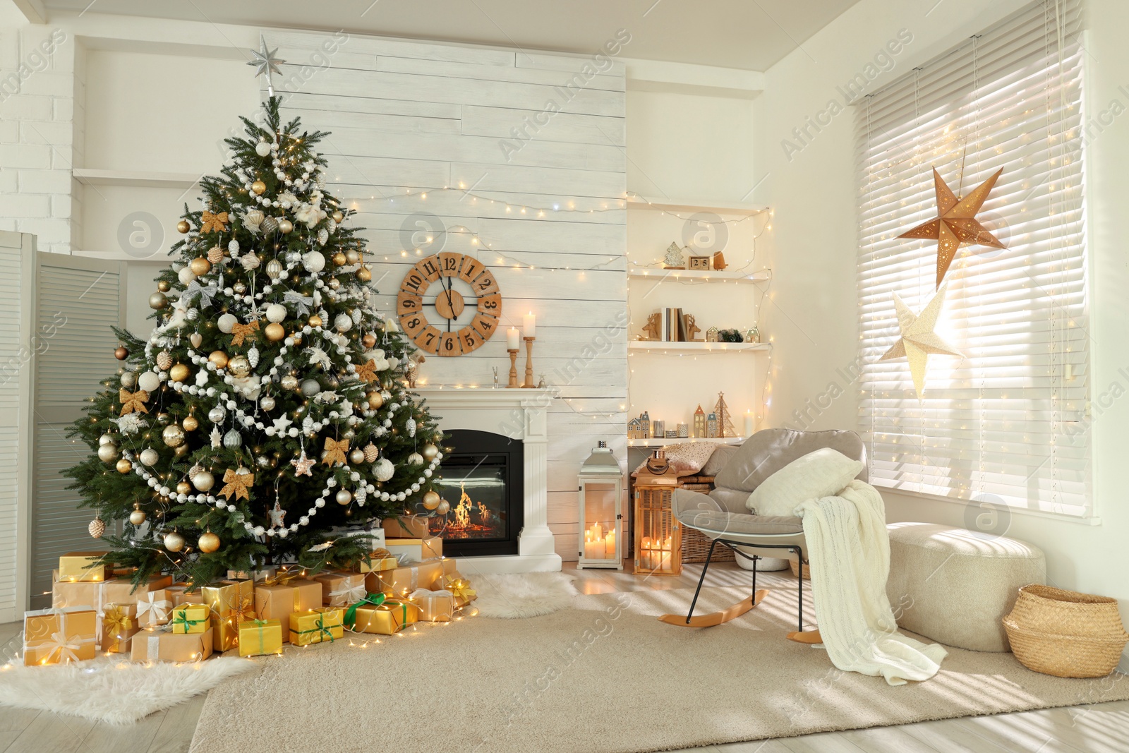 Photo of Decorated Christmas tree with gift boxes and fireplace in stylish living room interior