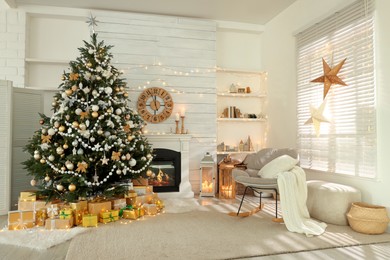 Photo of Decorated Christmas tree with gift boxes and fireplace in stylish living room interior