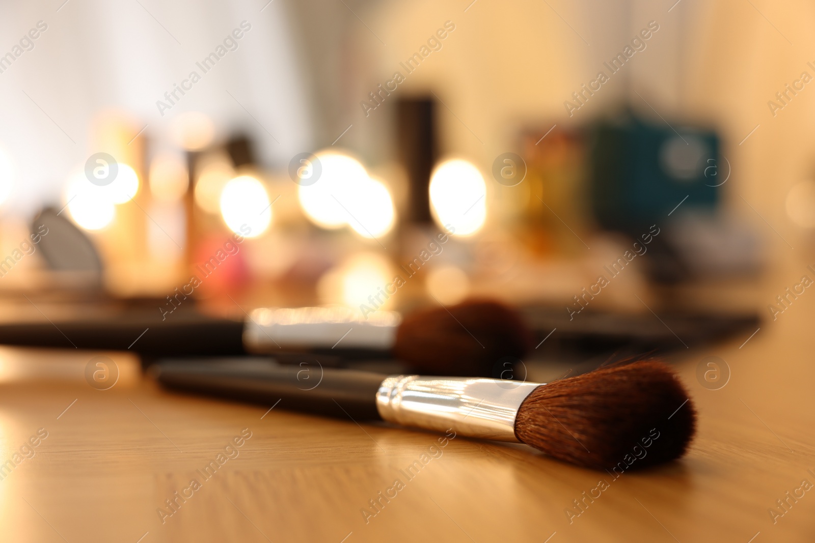 Photo of Makeup brush on wooden dressing table indoors