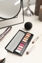 Photo of Mirror and cosmetic products on dressing table