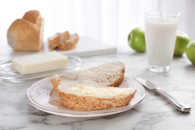 Photo of Fresh bread with tasty butter on plate