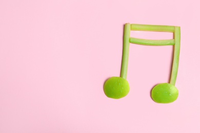 Photo of Musical note made of fruits and vegetables on color background, top view. Space for text
