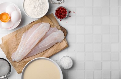 Photo of Different ingredients for batter and raw fish fillet on white tiled table, flat lay. Space for text