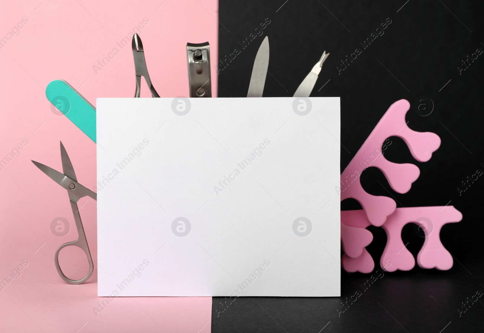 Photo of Set of manicure tools and blank card on color background. Space for text