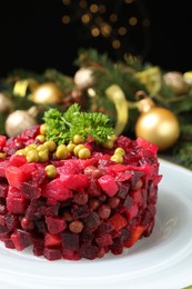 Photo of Traditional Russian salad vinaigrette on plate, closeup