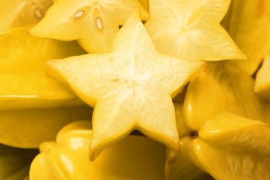 Photo of Cut and whole carambolas as background, closeup