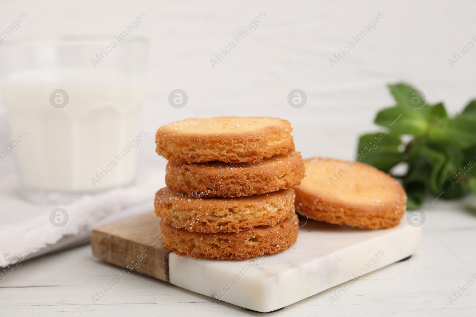 Photo of Tasty sweet sugar cookies on white wooden table, closeup