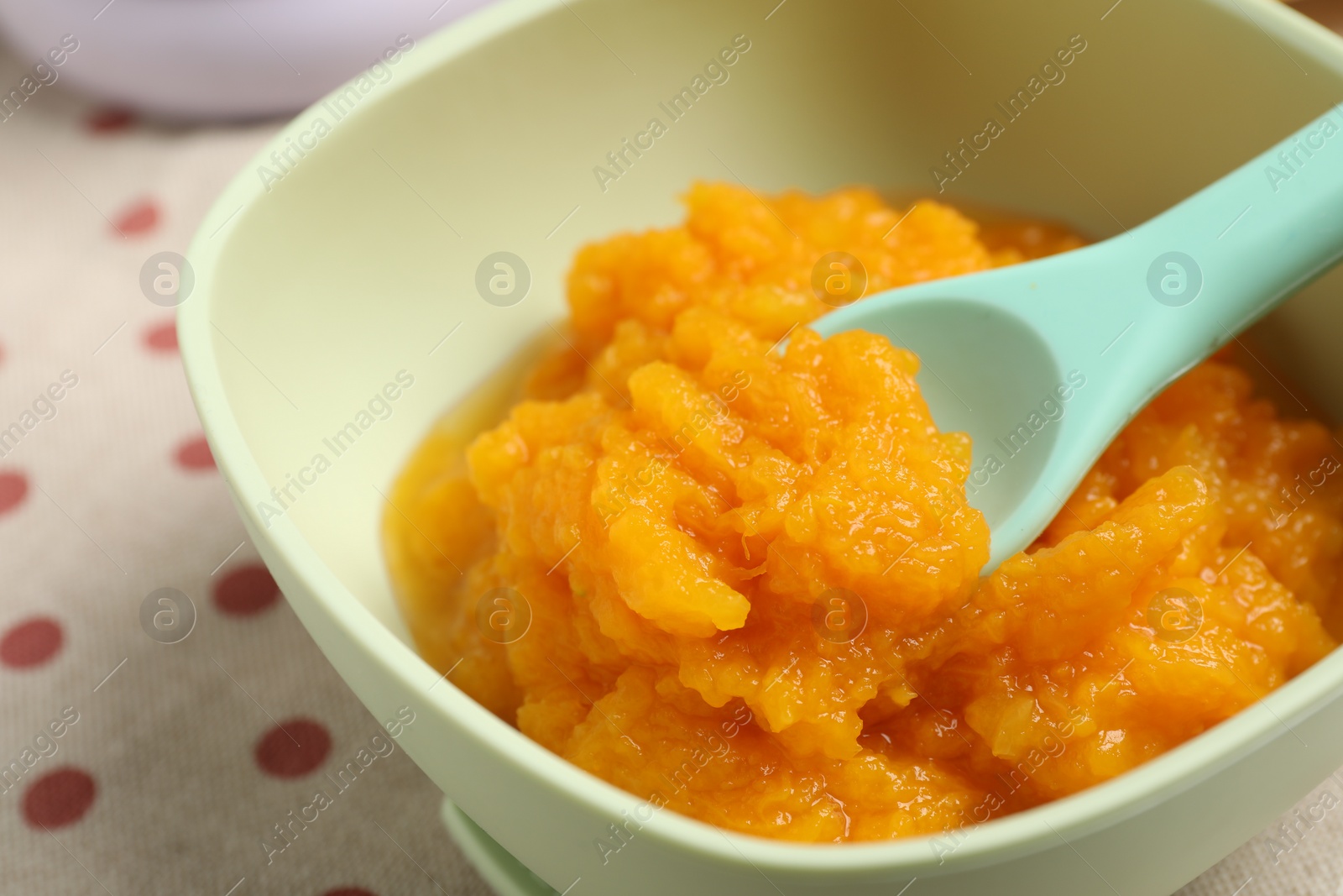 Photo of Baby food. Tasty pumpkin puree on table, closeup