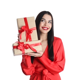 Woman in red dress holding Christmas gifts on white background