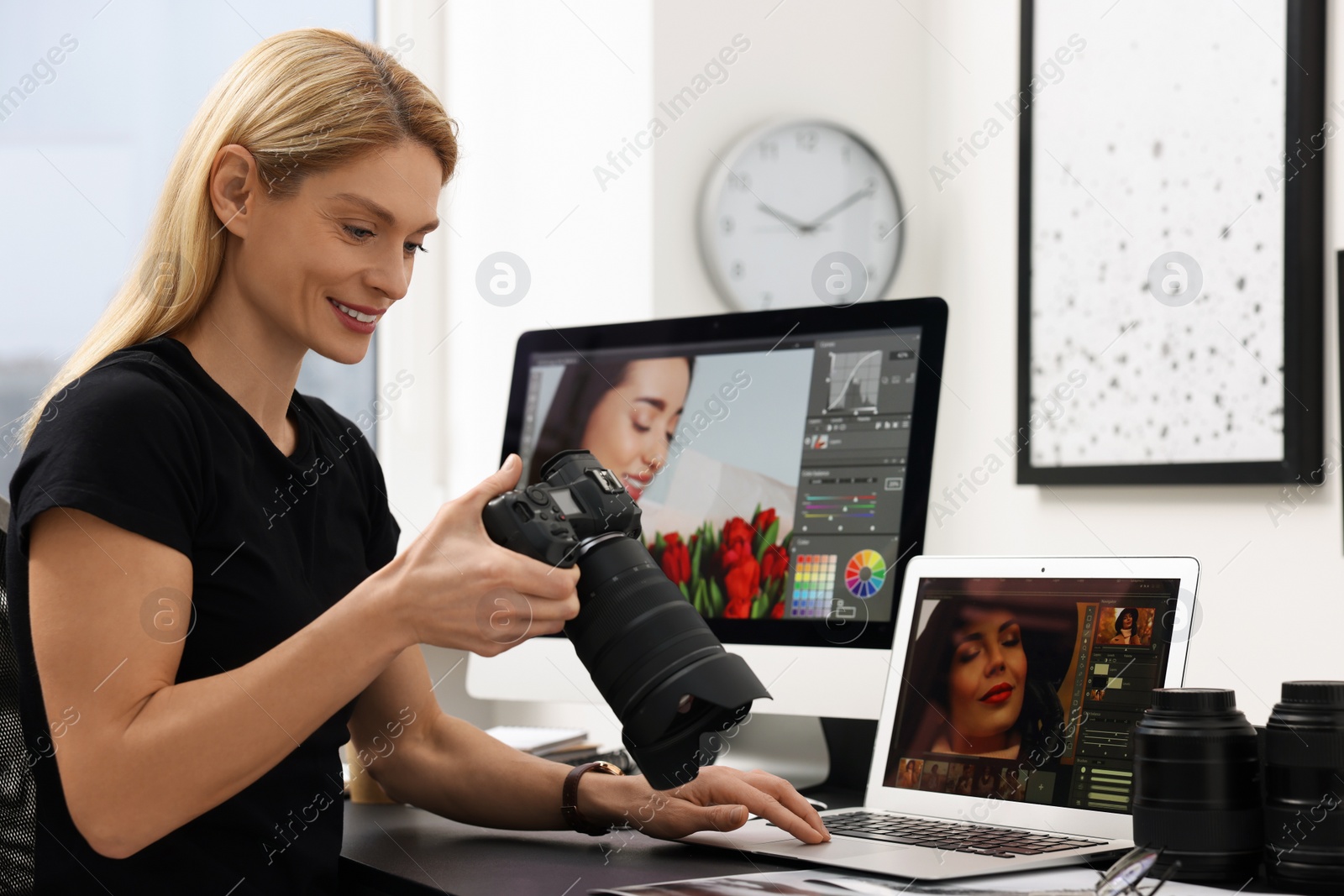 Photo of Professional photographer with digital camera at table in office