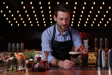 Photo of Bartender preparing Espresso Martini in bar. Alcohol cocktail