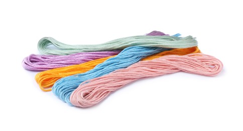 Photo of Set of colorful embroidery threads on white background