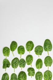 Photo of Fresh leaves of spinach isolated on white, top view