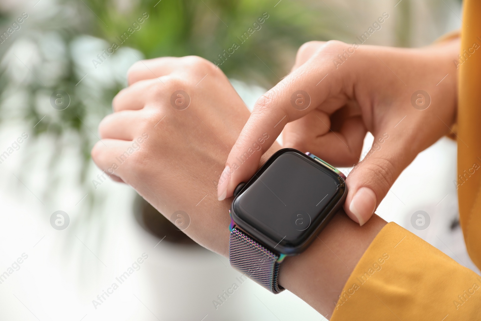 Image of Woman checking stylish smart watch at home, closeup