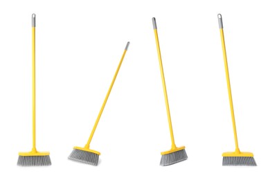 Image of Set with plastic brooms on white background