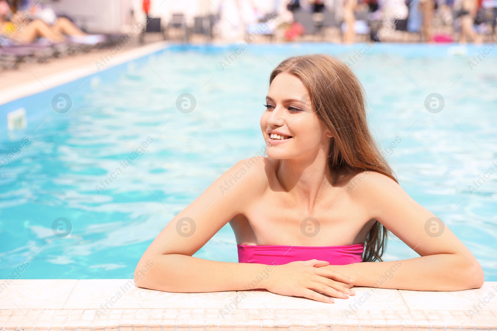 Photo of Young woman in pool on sunny day