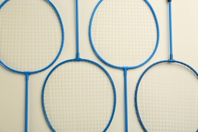 Photo of Badminton rackets on light background, flat lay