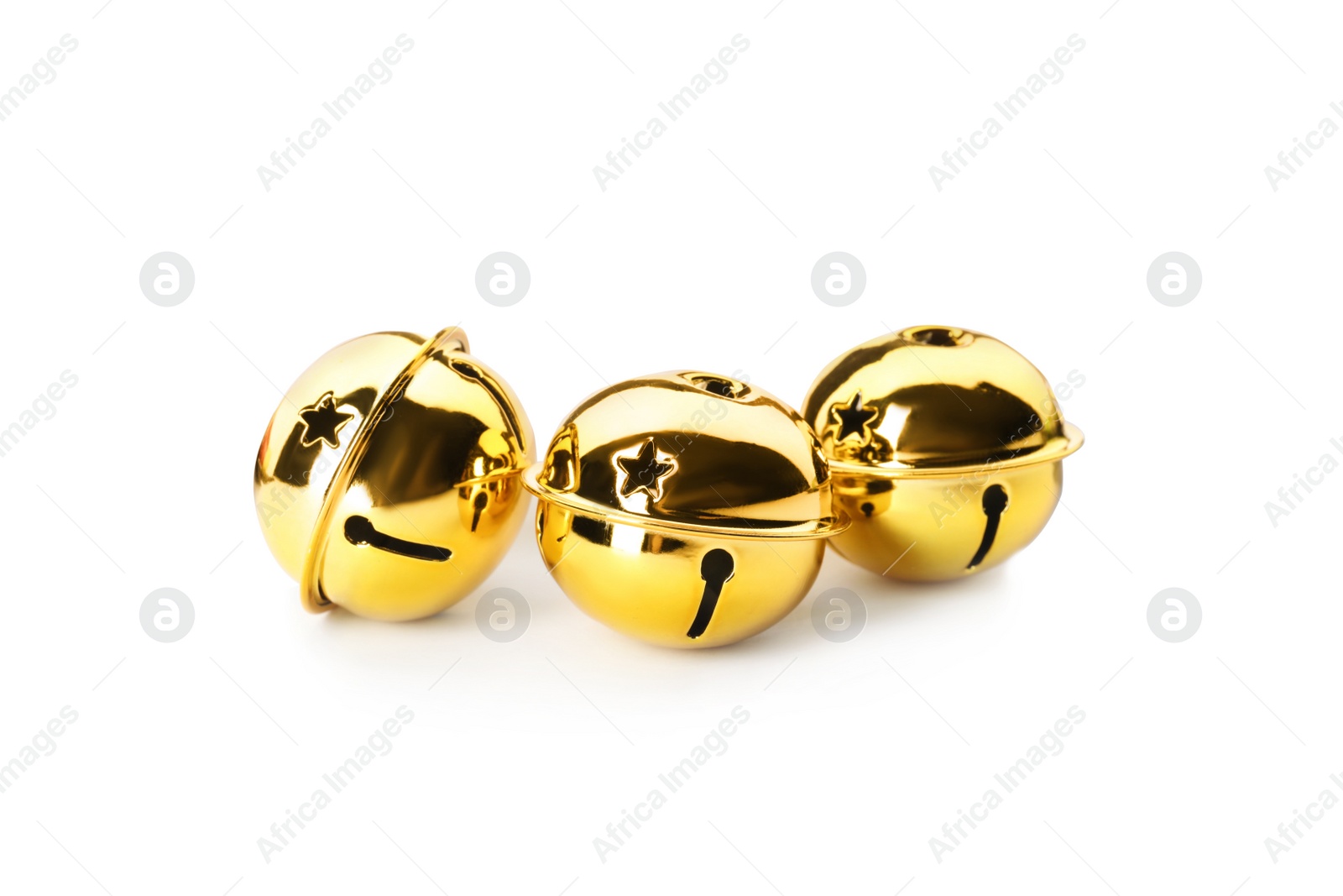 Photo of Shiny golden sleigh bells on white background