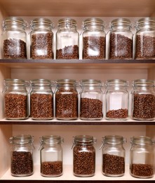 Photo of Glass jars with coffee beans on rack