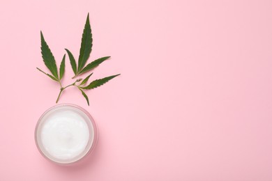 Photo of Glass jar of hemp cream on pink background, flat lay with space for text. Natural cosmetics