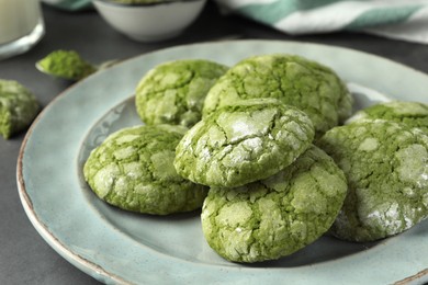 Photo of Plate with tasty matcha cookies on grey table, closeup