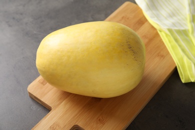 Photo of Whole ripe spaghetti squash on gray table