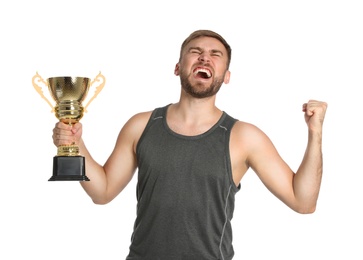 Photo of Portrait of happy young sportsman with gold trophy cup on white background