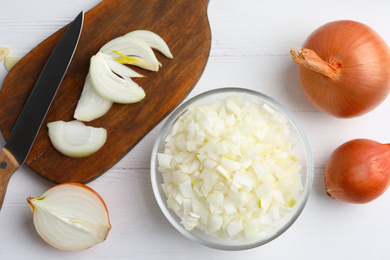 Photo of Flat lay composition with cut onion on white wooden table, flat lay