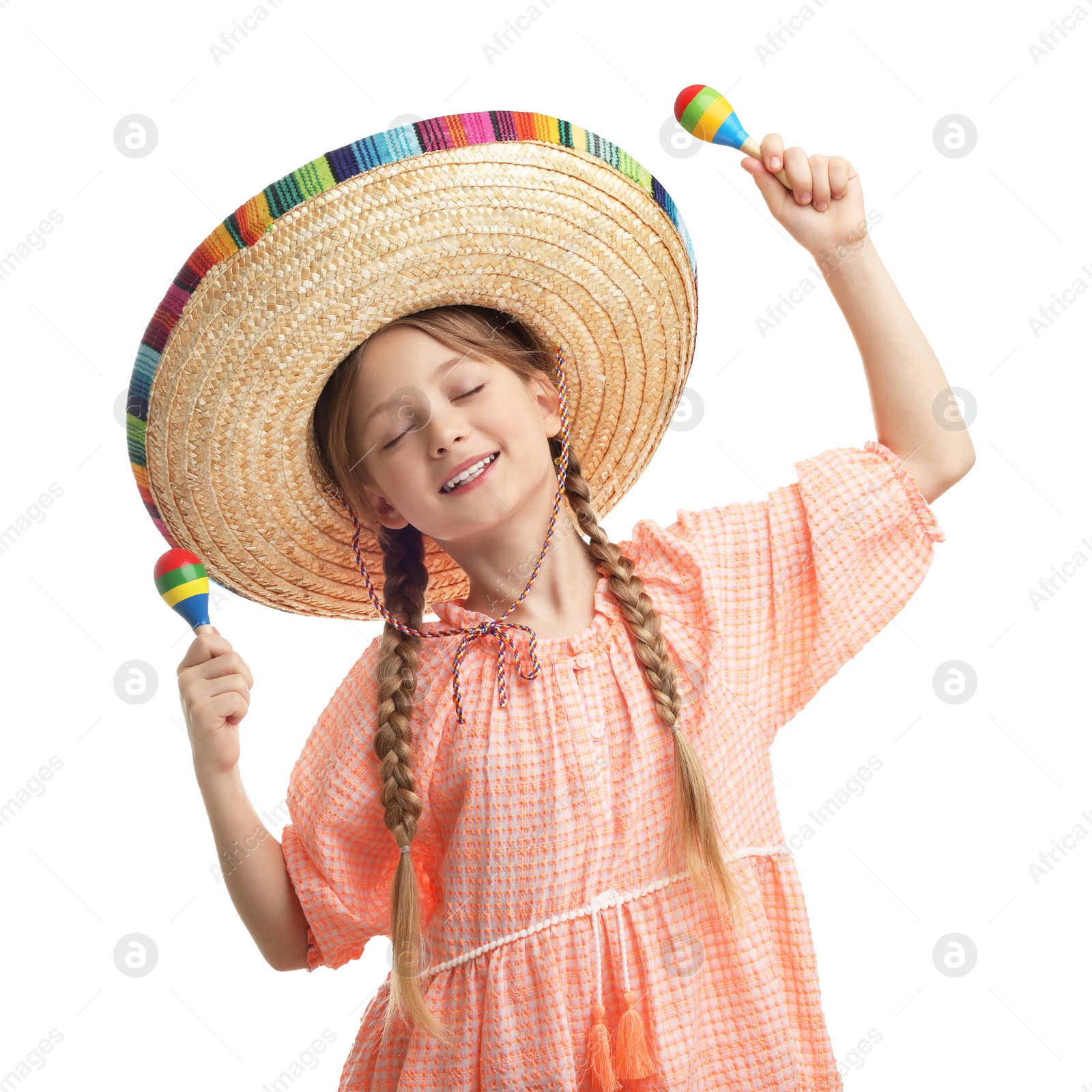 Photo of Cute girl in Mexican sombrero hat dancing with maracas on white background