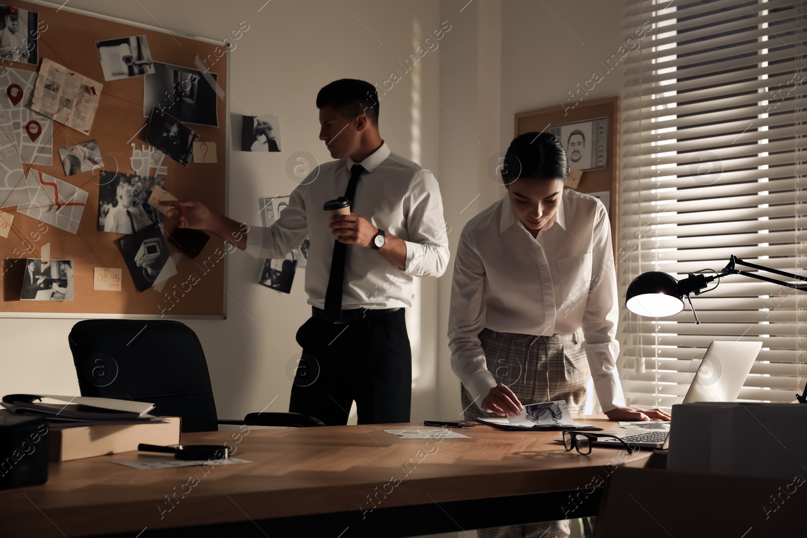 Photo of Professional detectives working on case in office