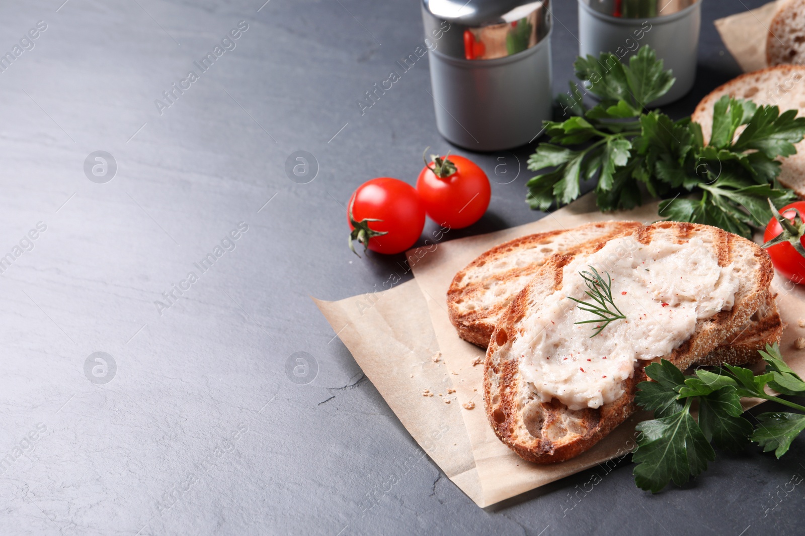 Photo of Toast with lard spread on black table. Space for text