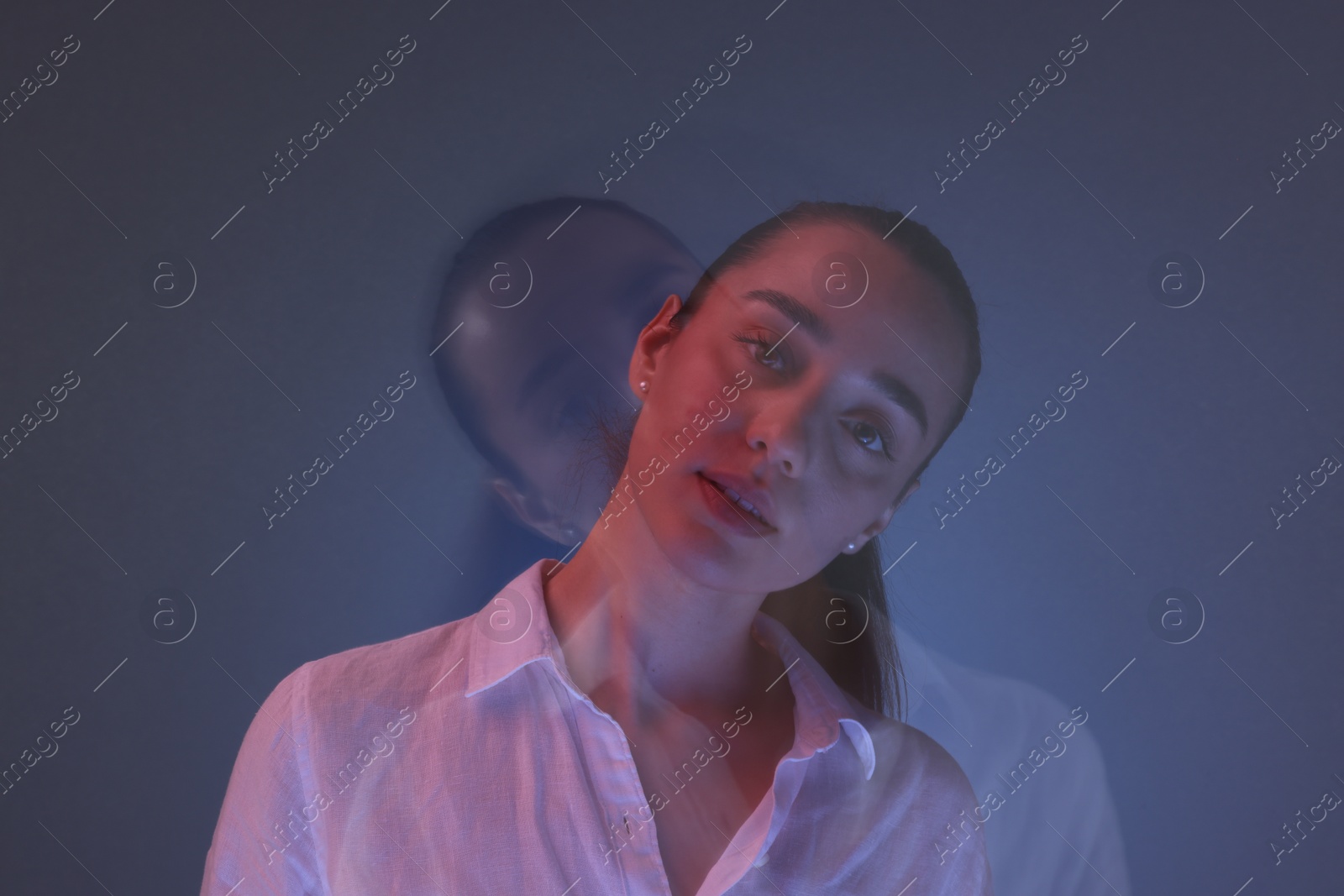 Photo of Portrait of beautiful young woman on color background, long-exposure photography