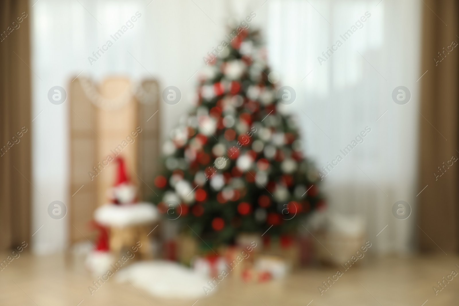 Photo of Blurred view of room interior with beautifully decorated Christmas tree