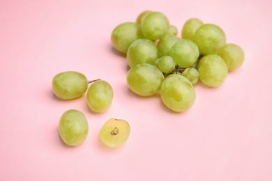 Photo of Fresh ripe juicy grapes on color background
