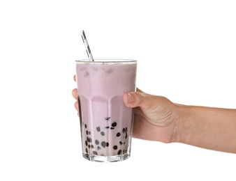 Woman holding glass of bubble milk tea with tapioca balls on white background, closeup