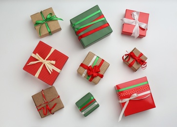 Flat lay composition with Christmas gift boxes on light background