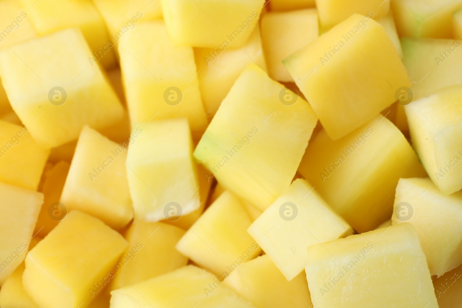 Photo of Many delicious mango cubes as background, closeup