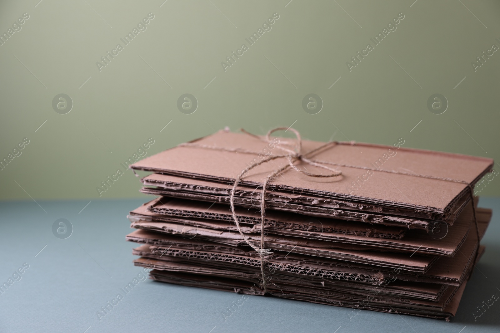 Photo of Stack of waste paper on grey table, space for text